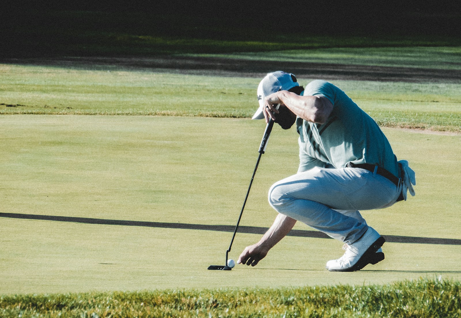 man holding black golf club